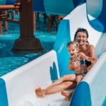 Mother and child on a water slide