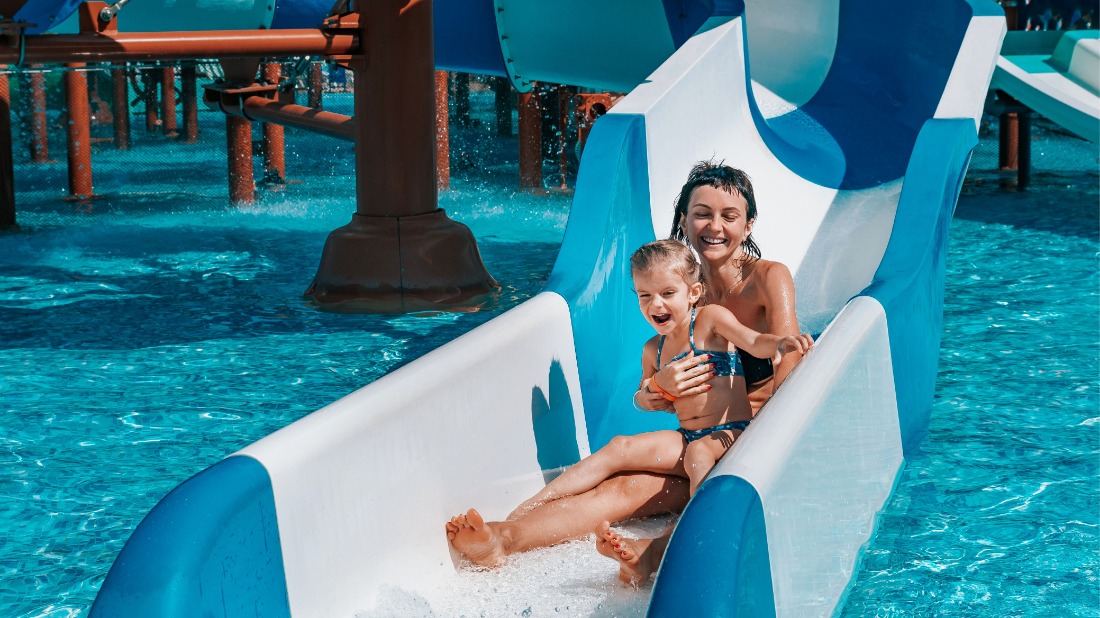 Mother and child on a water slide