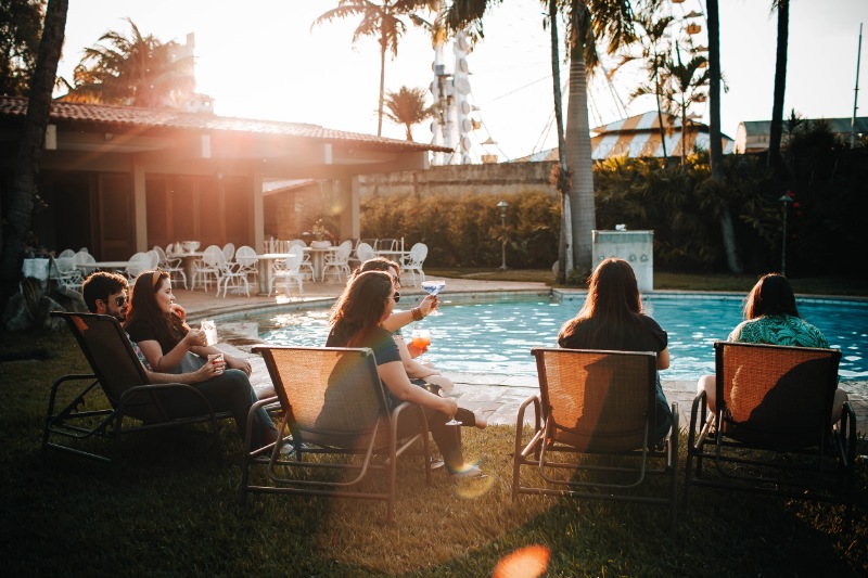 Group relaxing on a lounger by the pool