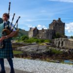 Castle and Scottish pipe musician in Scotland