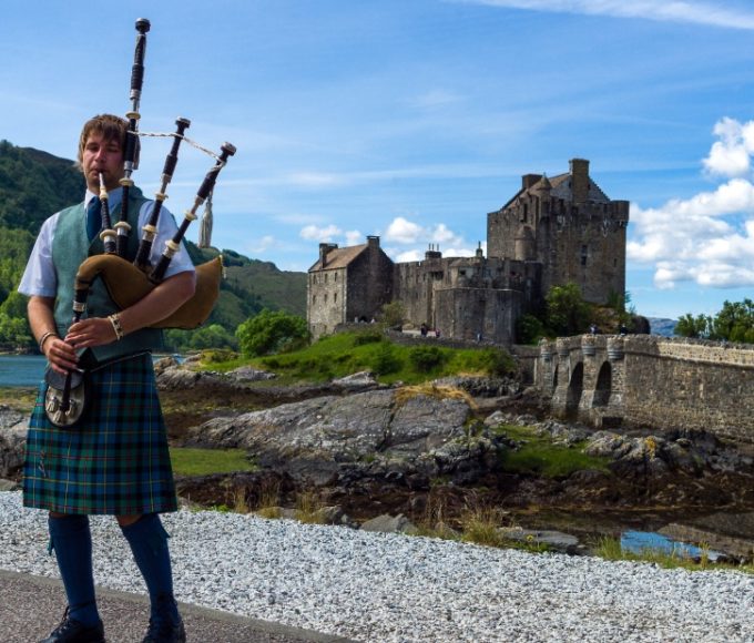 Castle and Scottish pipe musician in Scotland