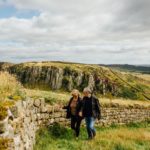 A couple strolling along Hadrian's Wall, North East England