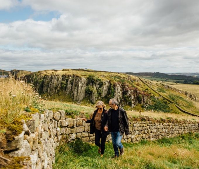 A couple strolling along Hadrian's Wall, North East England